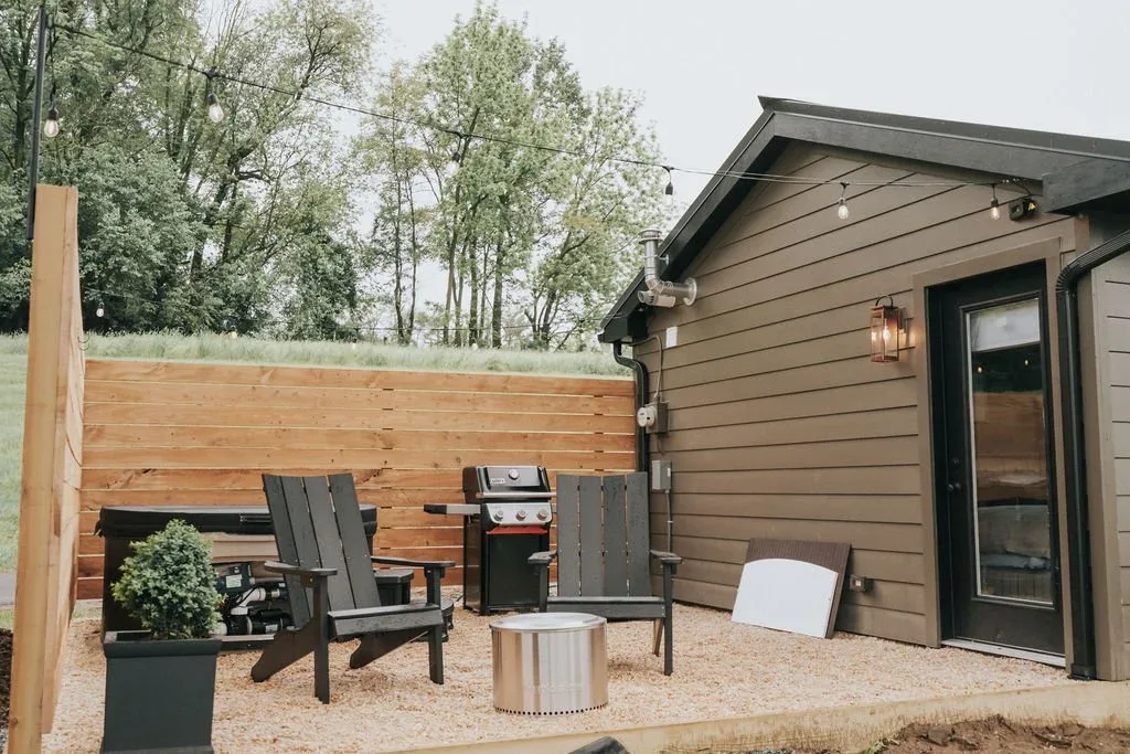 Exterior of a cabin at The Cabins at Beaver Creek with a deck and two bloack lounge chairs